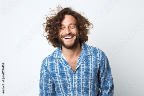 portrait of a happy Israeli man in his 30s wearing a snuggly pajama set against a white background photo