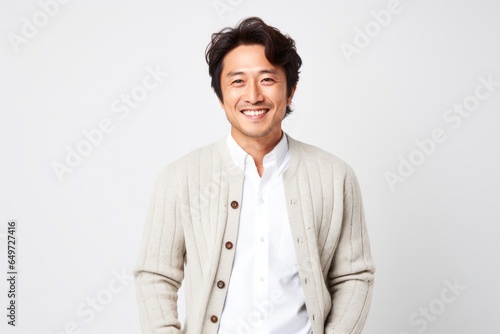 Wallpaper Mural portrait of a happy Japanese man in his 30s wearing a chic cardigan against a white background Torontodigital.ca