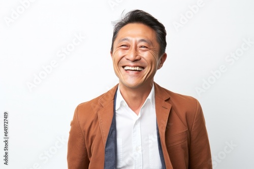 Obraz na płótnie portrait of a happy Japanese man in his 40s wearing a chic cardigan against a white background w salonie