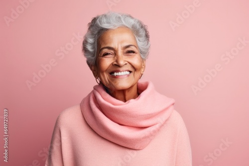medium shot portrait of a 100-year-old elderly Mexican woman wearing a cozy sweater against a pastel or soft colors background