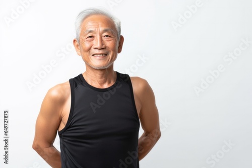 medium shot portrait of a 100-year-old elderly japanese man wearing a sporty tank top against a white background