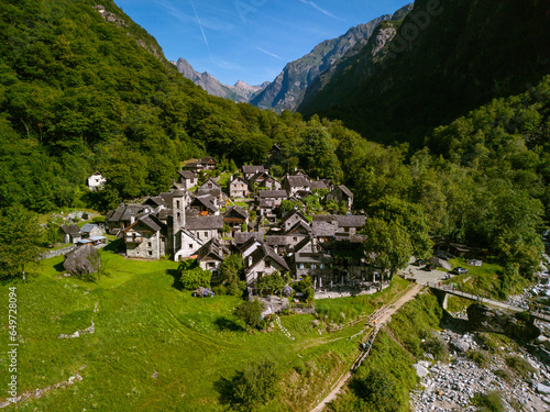 Summertime in an ancient town with stone houses and a waterfall, aerial view of Foroglio, Sabbione, Ticino, Switzerland photo