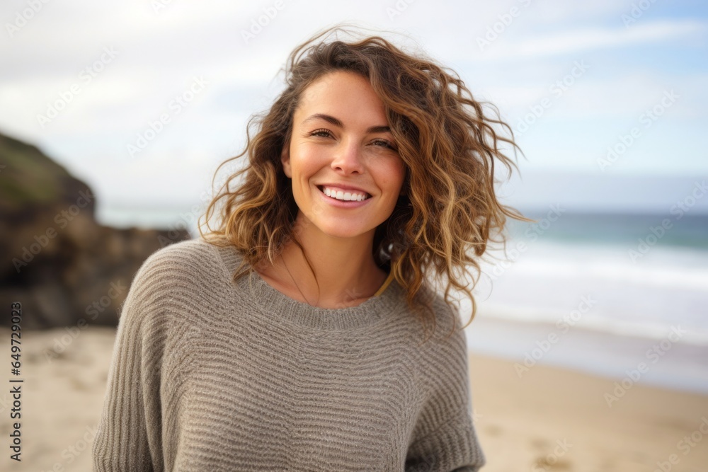 medium shot portrait of a Israeli woman in her 30s wearing a cozy sweater against a beach background medium shot portrait of a Israeli woman in her 30s wearing a cozy sweater against a beach background