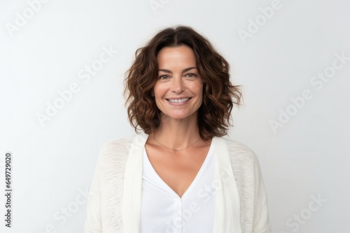 medium shot portrait of a Israeli woman in her 40s wearing a chic cardigan against a white background