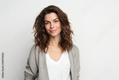 medium shot portrait of a Israeli woman in her 30s wearing a chic cardigan against a white background