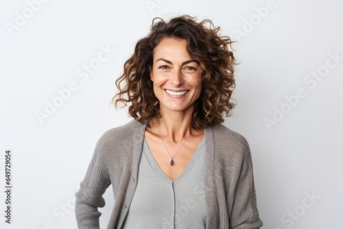medium shot portrait of a Israeli woman in her 40s wearing a chic cardigan against a white background