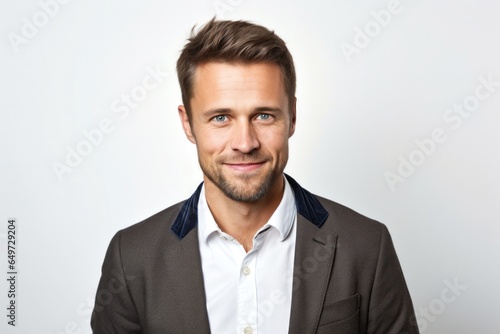 portrait of a happy Polish man in his 30s wearing a chic cardigan against a white background