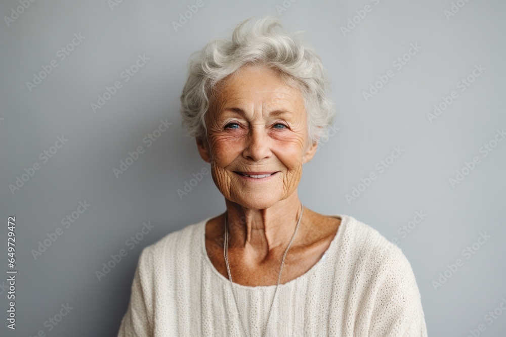 portrait of a happy Polish woman in her 80s wearing a chic cardigan against a minimalist or empty room background portrait of a happy Polish woman in her 80s wearing a chic cardigan against a minimalist or empty room background