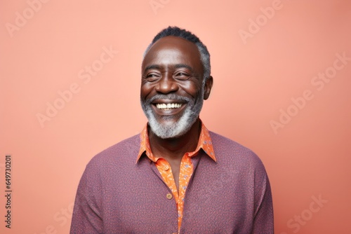 medium shot portrait of a Kenyan man in his 50s wearing a chic cardigan against an abstract background