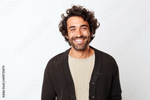 medium shot portrait of a Mexican man in his 30s wearing a chic cardigan against a white background