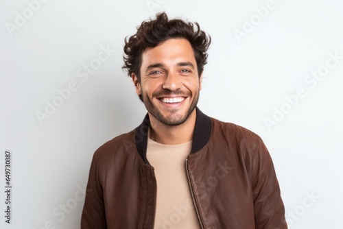 portrait of a Israeli man in his 30s wearing a chic cardigan against a white background © Leon Waltz