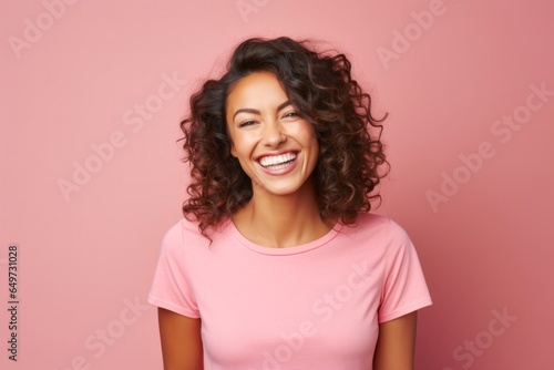 medium shot portrait of a Mexican woman in her 30s wearing a fun graphic tee against a pastel or soft colors background