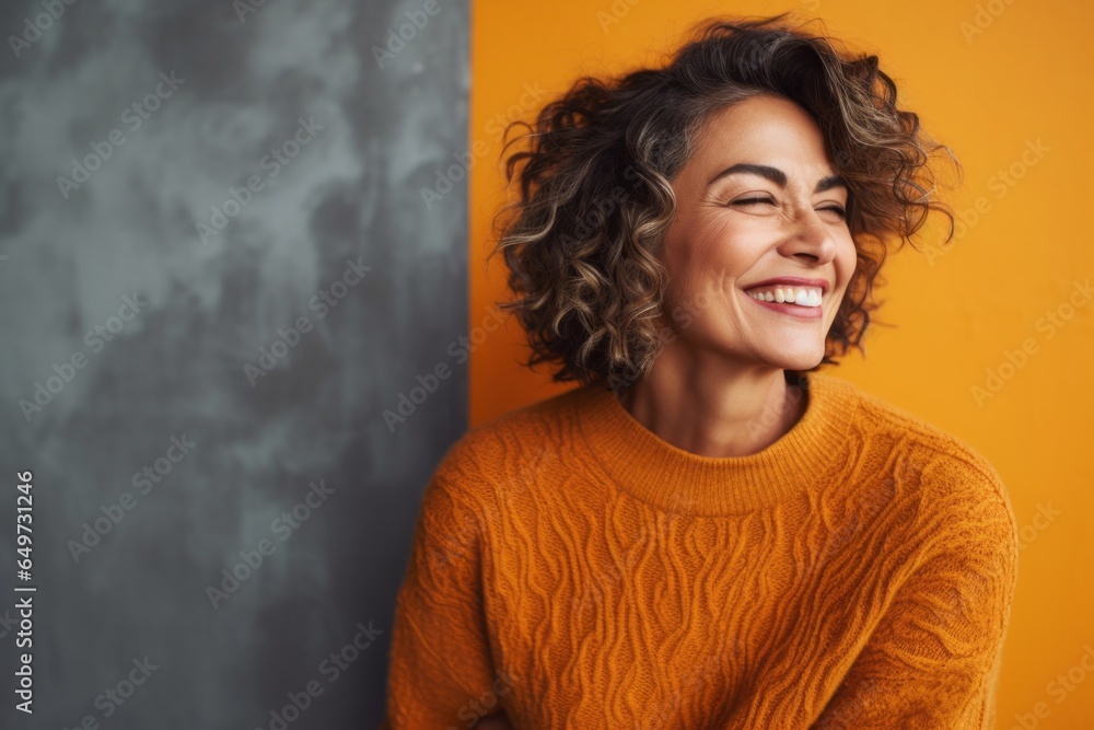 medium shot portrait of a Mexican woman in her 50s wearing a cozy sweater against an abstract background medium shot portrait of a Mexican woman in her 50s wearing a cozy sweater against an abstract background