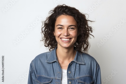 portrait of a Israeli woman in her 30s wearing a denim jacket against a white background