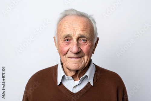 medium shot portrait of a Polish man in his 90s wearing a chic cardigan against a white background © Anne-Marie Albrecht