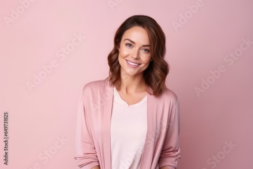 medium shot portrait of a Polish woman in her 30s wearing a chic cardigan against a pastel or soft colors background