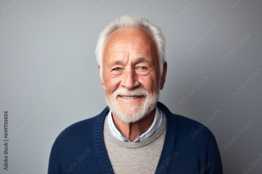 portrait of a Polish man in his 70s wearing a chic cardigan against a minimalist or empty room background portrait of a Polish man in his 70s wearing a chic cardigan against a minimalist or empty room background