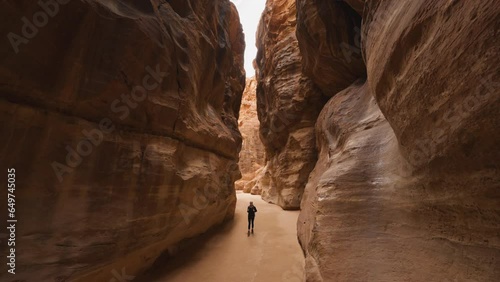 Girl walking through the Siq Canyon heading towards the Treasury of Petra