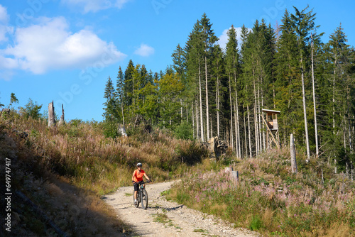 nice senior woman on her electric mountain bike cycling in the German Black Forest near Titisee-Neustadt, Baden-Württemberg, Germany
