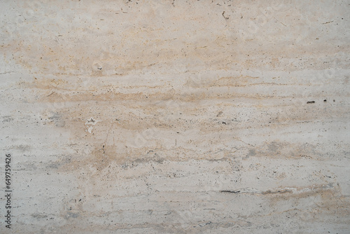 White marble granite wall. The facing facade of the building as a background of natural stone.