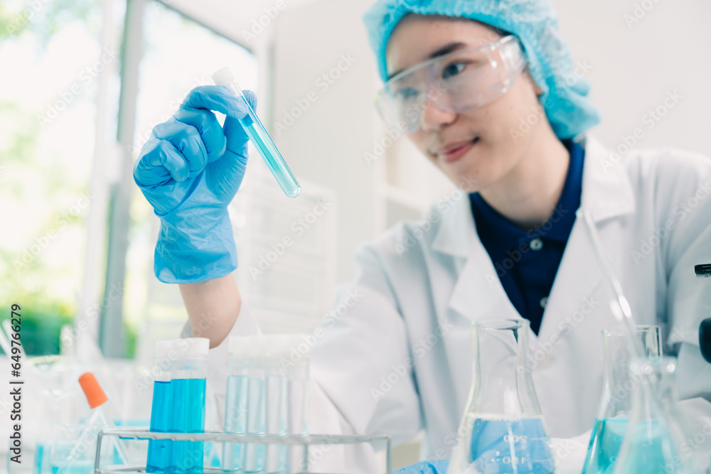 Fototapeta premium Scientist analyzing and dropping a sample into a glassware, Medicine science experiments containing chemical liquid in laboratory on glassware, innovative and technology.