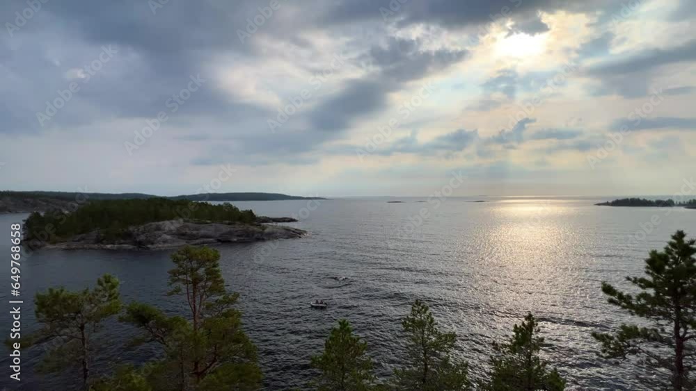 Russia, Karelia, Lake Ladoga, Koyonsaari. View of the coast of the island in a cold lake. Beautiful nature of the Republic of Karelia. Stunning panoramic view of the Ladoga Skerry Islands. 4K