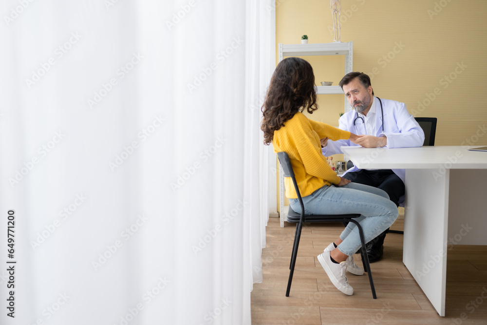 Doctor examining the patient's arm and upper arm in doctor's room. Medical and healthcare concept.