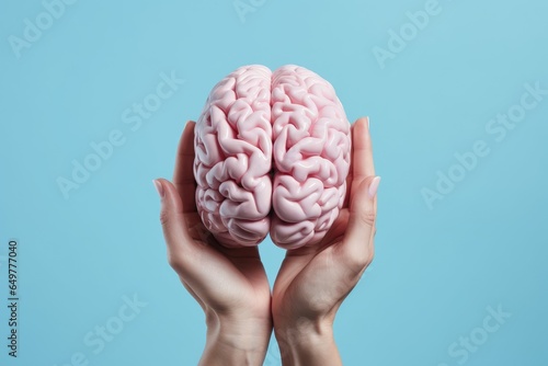 human hands hold brain model health concept