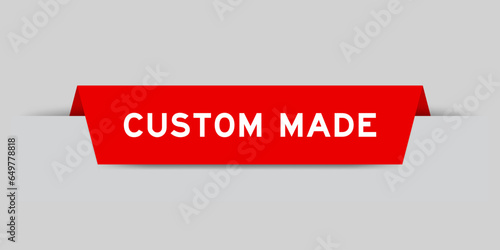 Red color inserted label with word custom made on gray background
