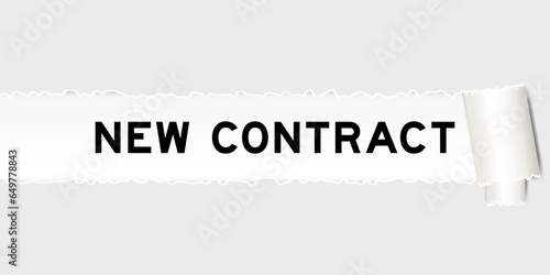 Ripped gray paper background that have word new contract under torn part