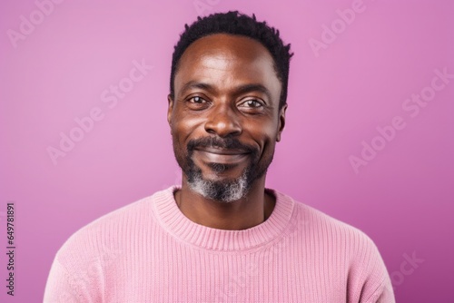Happiness and smiles: Front view of a smiling adult with a beard on a colored background