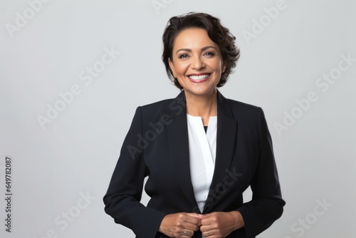 Successful businesswoman with a confident smile and crossed arms in corporate setting