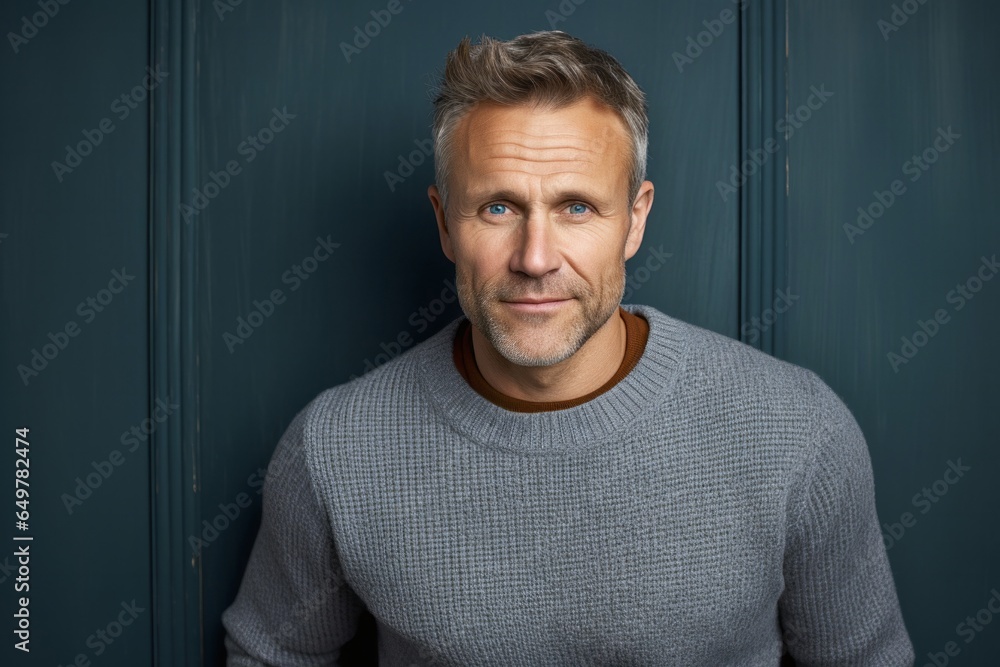 Confident mature man with friendly smile and attractive beard in casual sweater portrait