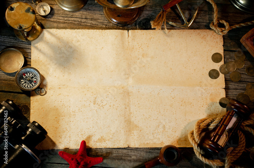 Treasure island concept on a wooden table background. Sheet of paper for text or map