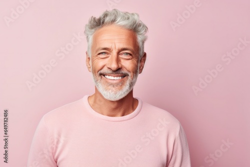 Obraz na płótnie Smiling elderly person with gray and white hair in colored background w salonie