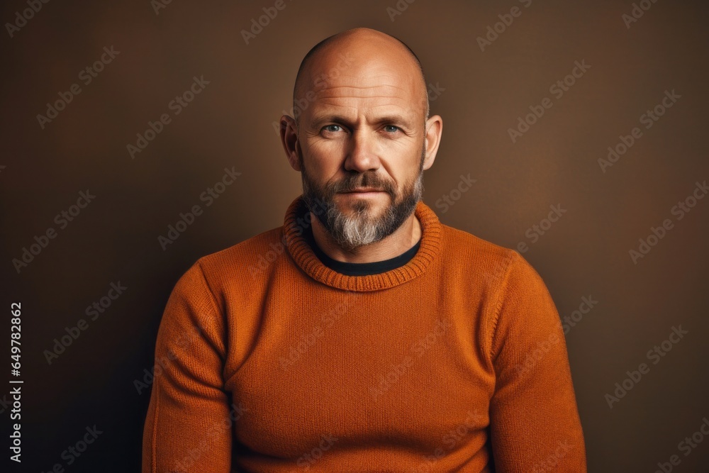 Confident mature man with a beard smiling in casual sweater