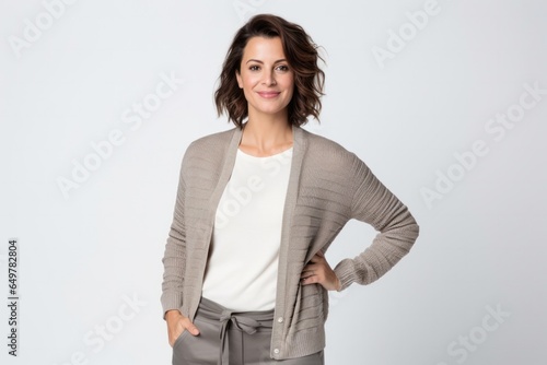 Obraz na płótnie Smiling woman in patterned outerwear standing on white background w salonie
