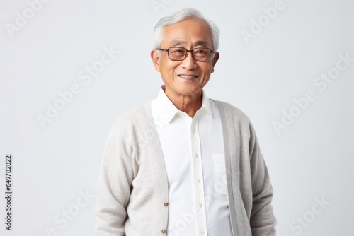 Obraz na płótnie Happy senior man in casual clothing smiling at camera with glasses in studio portrait w salonie