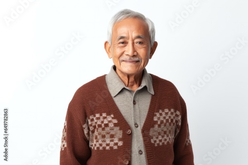Obraz na płótnie Smiling senior man with gray beard and sweater, studio portrait on blank background w salonie