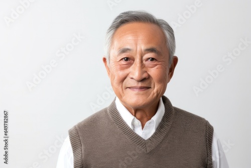 Obraz na płótnie Cheerful senior man with gray hair smiling for camera on white background w salonie