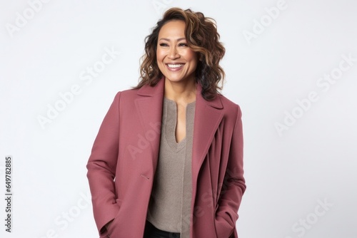 Cheerful woman with curly hair and grinning smile standing on white background