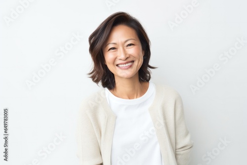 Cheerful mature woman smiling at camera on white background