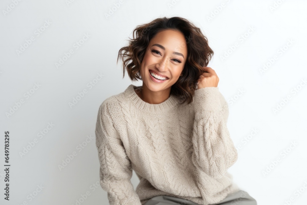 Cheerful woman with curly hair smiling in white studio portrait Cheerful woman with curly hair smiling in white studio portrait