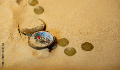 Vintage comass on sand among shells and stones. photo