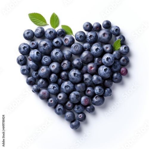 Heart shape made from blueberries with green leaves, isolated on white background