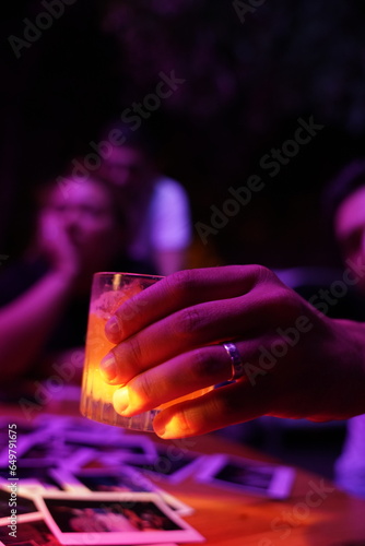 person holding a glass of Cocktail 
