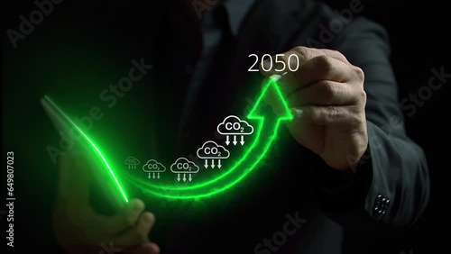 Businessman holding tablet with increasing arrow and carbon reduction for decrease CO2, carbon footprint and credit to limit global warming from climate change. Bio circular green economy concept. photo