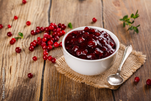 Portion of homemade cranberry sauce. Cranberry jam in white ceramic bowl. Copy space