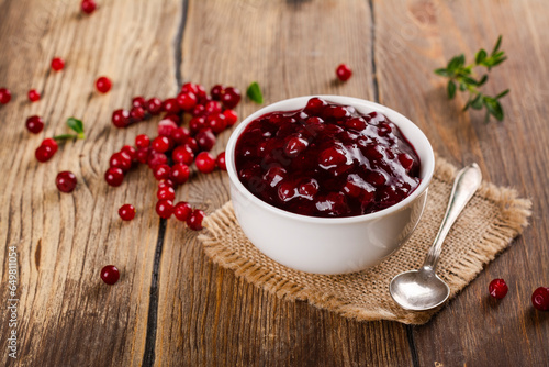 Portion of homemade cranberry sauce. Cranberry jam in white ceramic bowl. Copy space photo