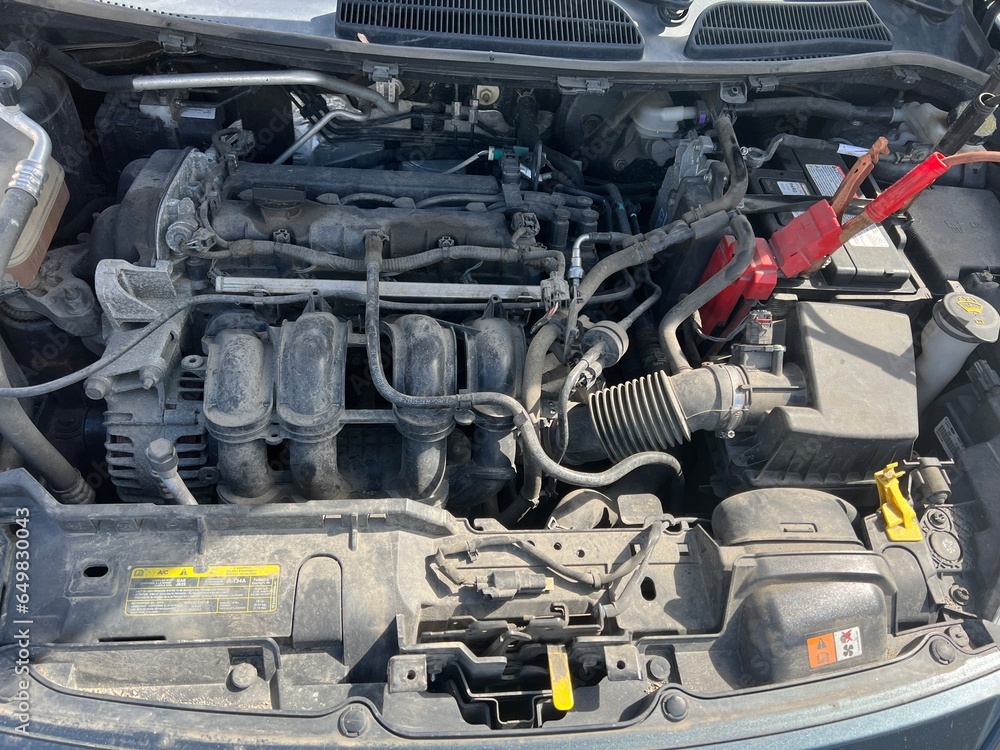Charging a car battery in winter. Help on the road. Closeup. Connecting high voltage wires to